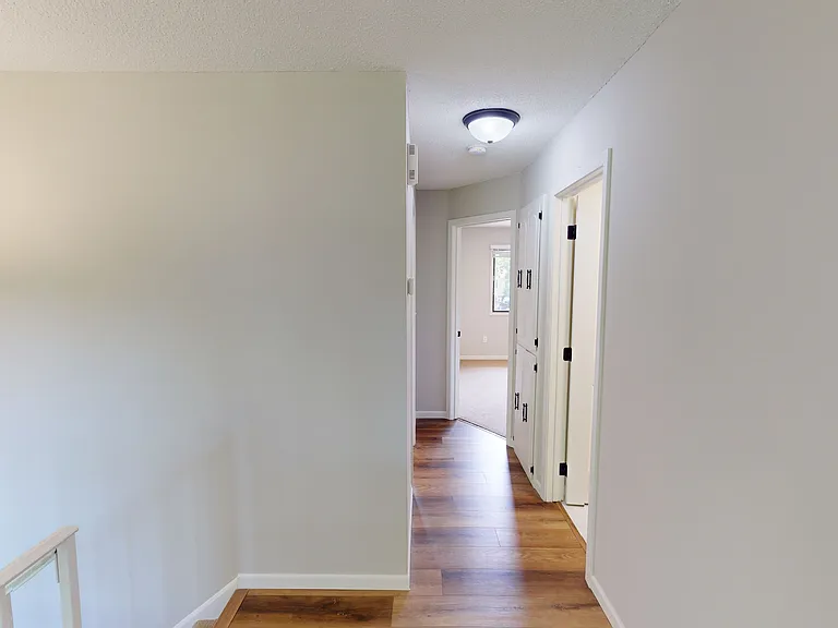 Upstairs hallway, view looking towards two bedrooms and the full bathroom.