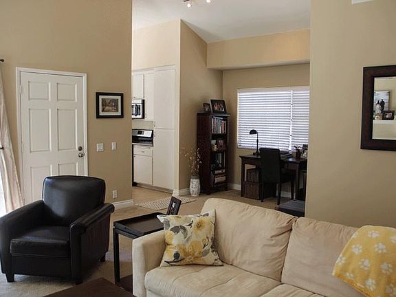 Living Room and Bonus Room with furniture in it. Paint and carpet have been updated since this photo was taken.