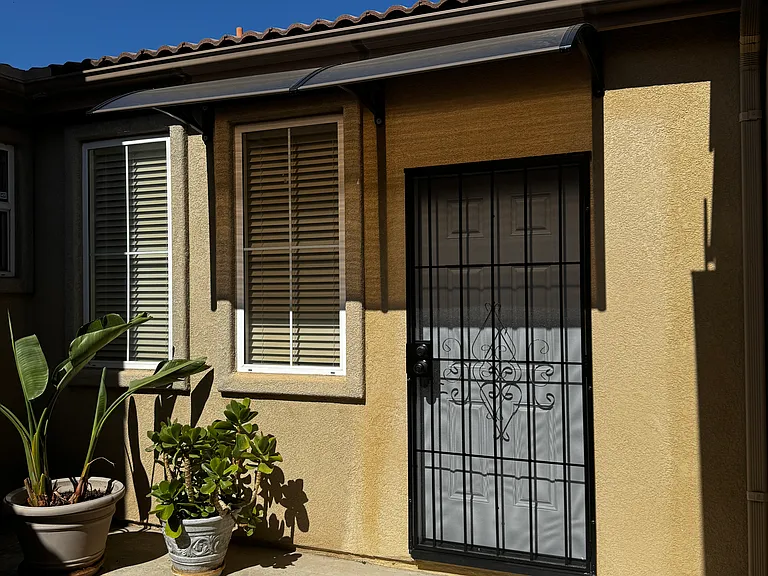 Attractive, separate, private entry patio with private door with security screen for rental room residents.