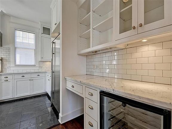 Bulter's pantry with wine fridge and chef's desk.