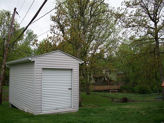 8' x 16' Storage shed with new gutters (notice the entire back yard is fenced)