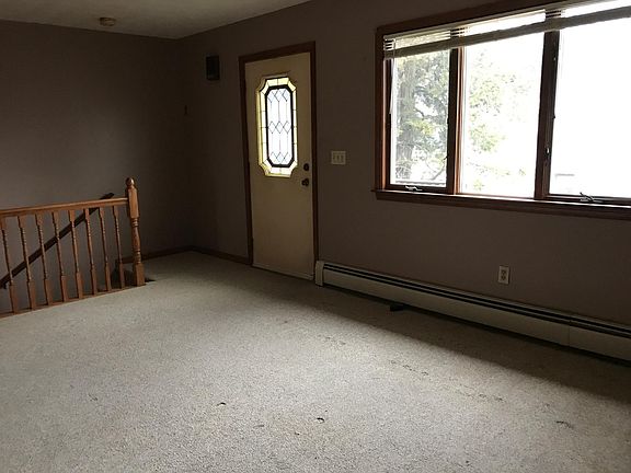 Foyer plus stairs going down to kitchen and second bedroom and laundry room.