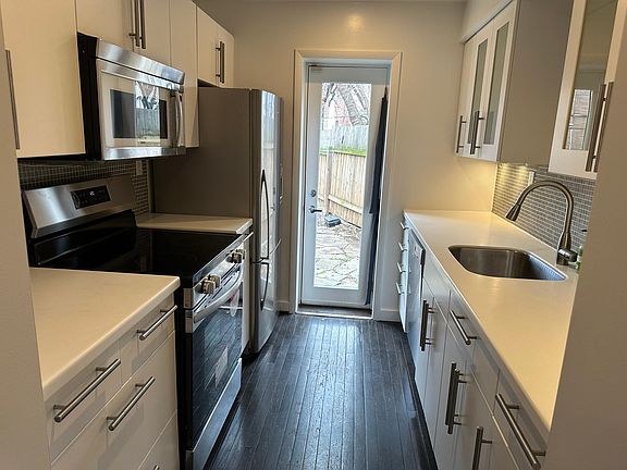 Kitchen with microwave, dishwasher and new oven.