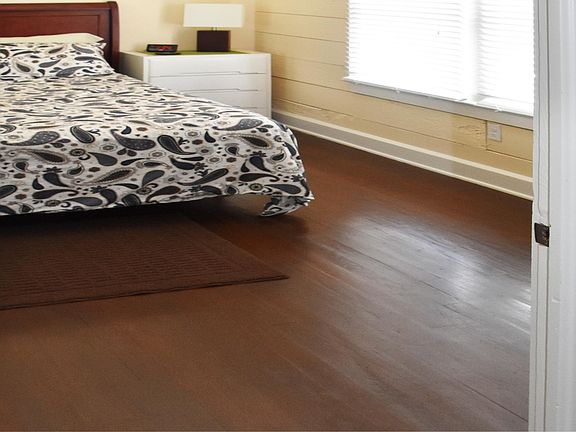 Spacious master bedroom with hardwood floors