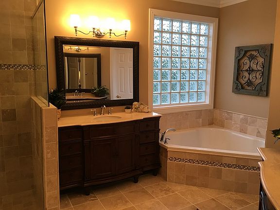 Remodeled Master Bath : New Travertine tile, new vanities, new oversized soaker tub