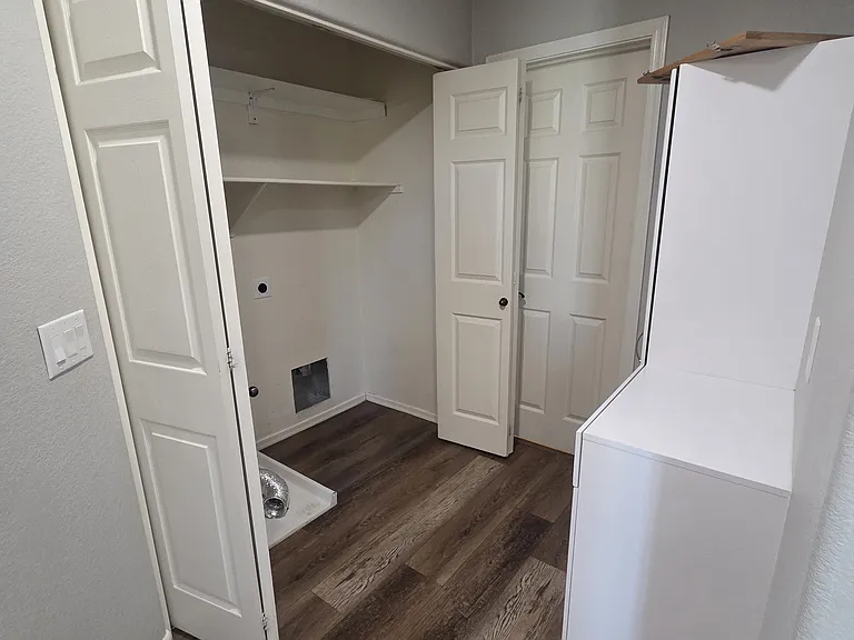 Laundry room and cabinets for storage.