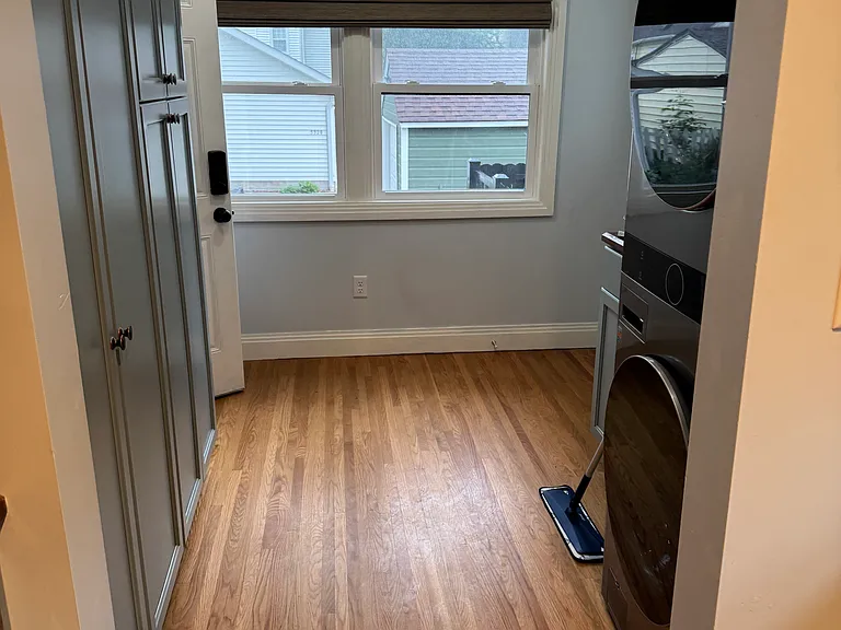 upstairs mudroom with storage and laundry, and entrance to fenced yard.