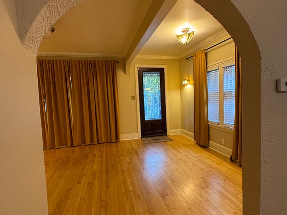 Leaded glass mahogany front door with custom storm door- screen for summer months, glass for winter. Archway from Dining Room to Living Room