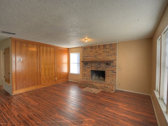 Spacious living room with brick fireplace