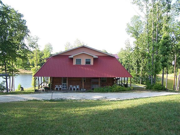 Front of house surrounded by lake