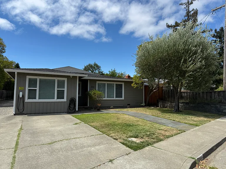Front of House with one off street parking and EV charging.