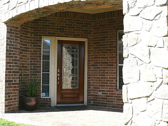 Front porch  with a beautiful  beveled glass door recently refinished.