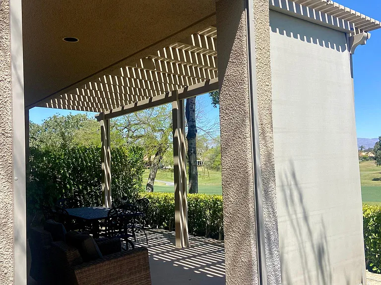 A spacious private backyard patio with automatic shades for added comfort and extra privacy and sun protection.