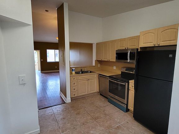 Kitchen facing living room and entrance.