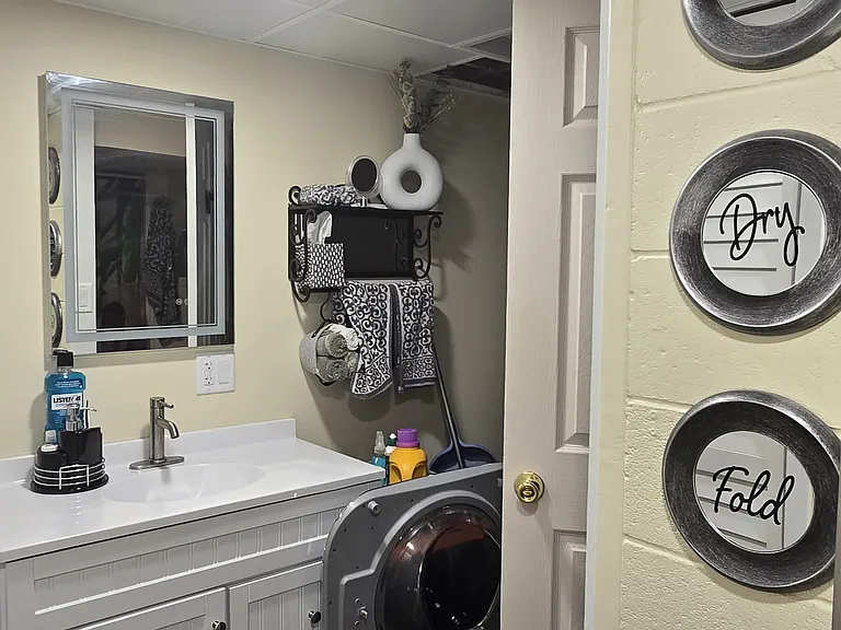 "Bathroom and laundry area designed for comfort and convenience with washer/dryer access and updated fixtures.
