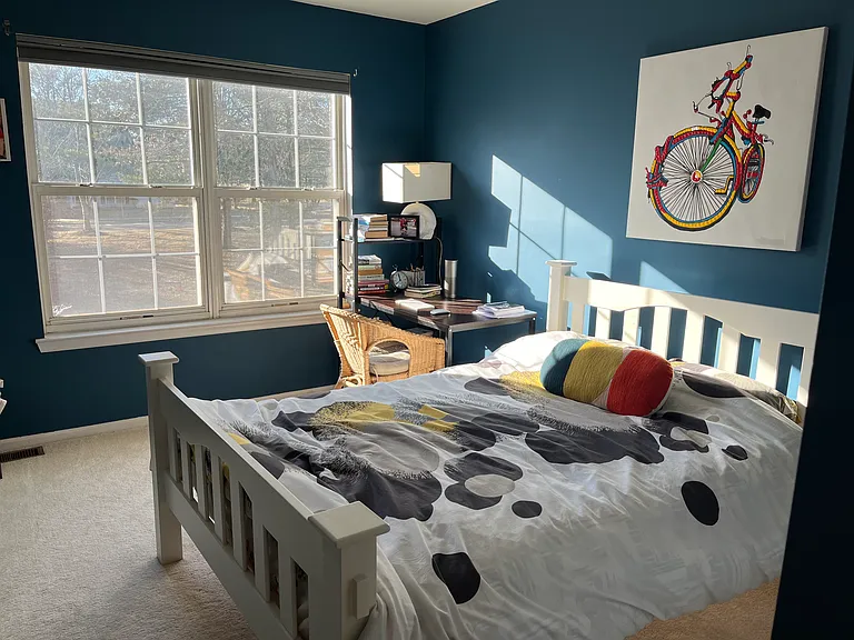 Secondary bedroom- with queen size bed and a decent size study table and a side table