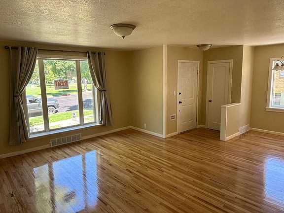 Living room with coat closet and large window