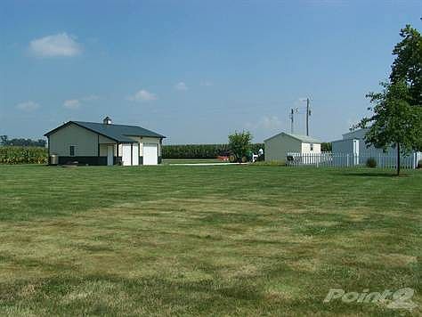 Back view with garage & outbuilding