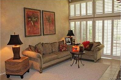 Spacious living room with high ceiling and gorgeous windows.