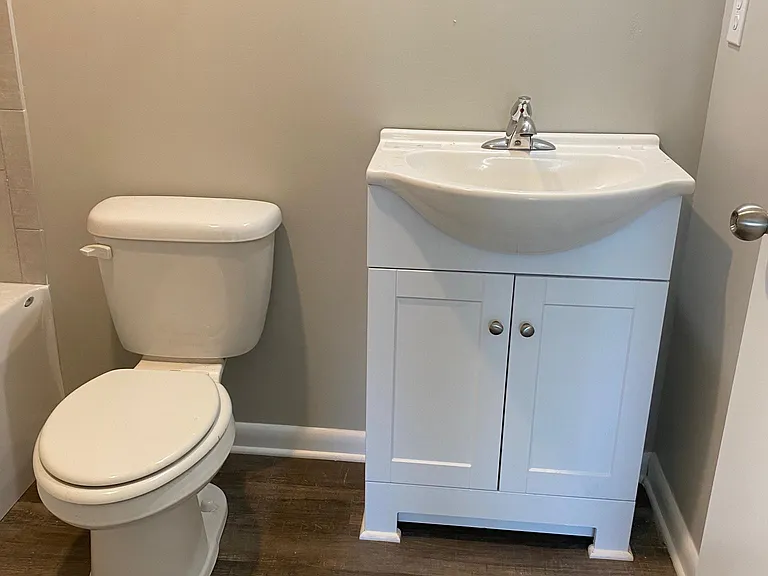 Sleek look new bathroom as part of 125K remodel. Tile surround tub and easy care luxury vinyl plank flooring. Convenient storage under the bathroom sink.