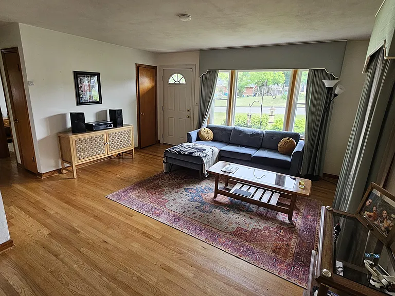 Living room shown furnished for layout example only. Rental is offered unfurnished.