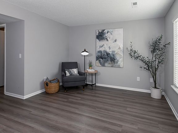 This inviting living area features modern decor, comfortable seating, and ample natural light, creating a perfect space for relaxation and leisure.
