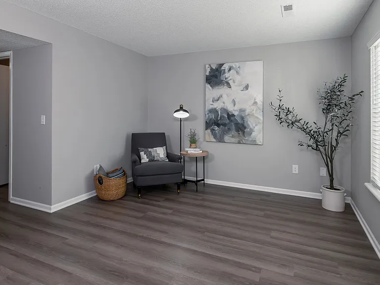 This inviting living area features modern decor, comfortable seating, and ample natural light, creating a perfect space for relaxation and leisure.