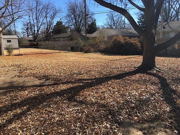 Fenced back yard with nice shade tree