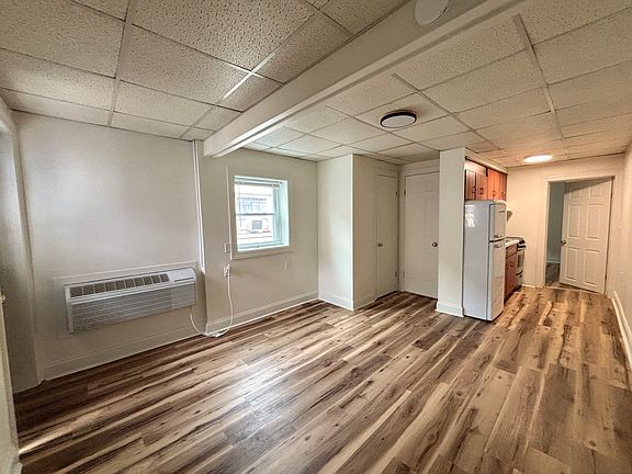 Main living space facing kitchen, bathroom, and small closet