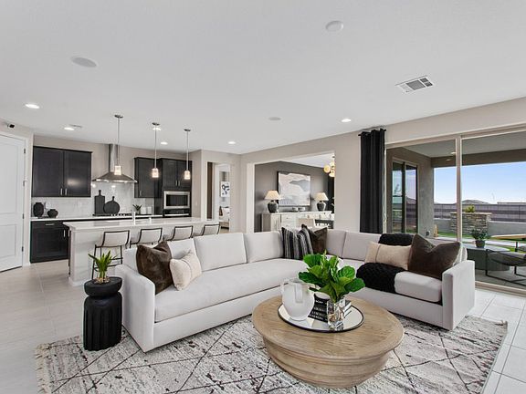 The gathering room opens to the kitchen and cafe, as well as the covered patio and backyard for indo