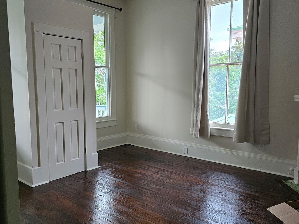 Grand and spacious bedroom with original fireplace and closet.
