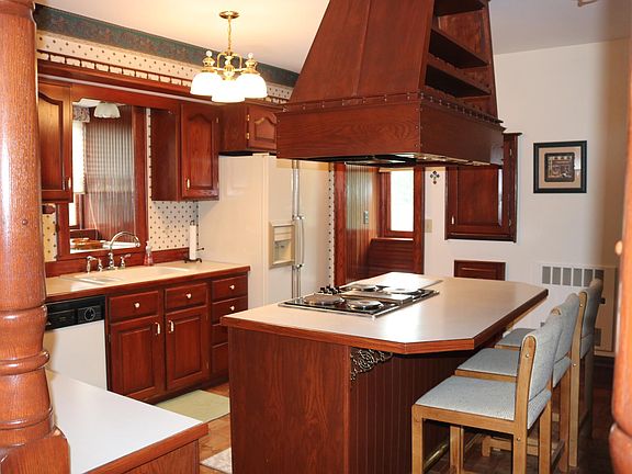 Kitchen - Wine rack, refrigerator, stove top, oven, dishwasher, counter top seating area.