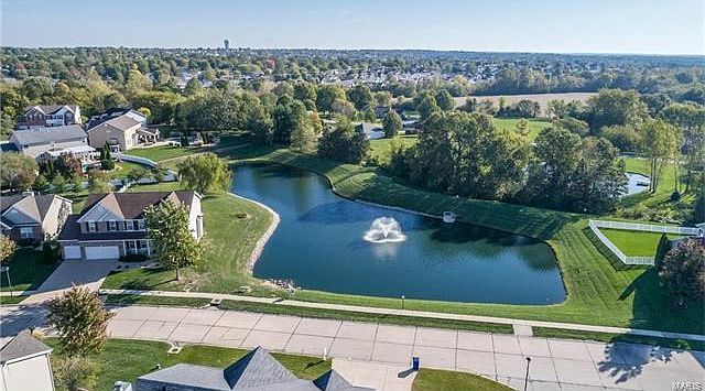 Shows front of house and the entire lake