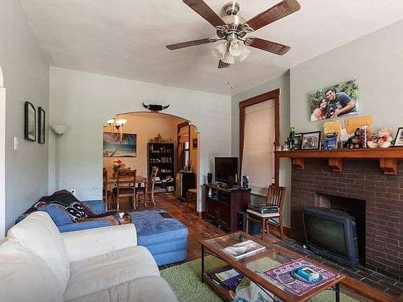living room through arch showing dining room