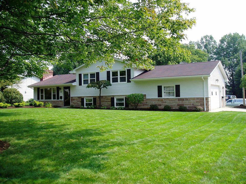 Professionally landscaped split level home w/ 2 1/2 car garage