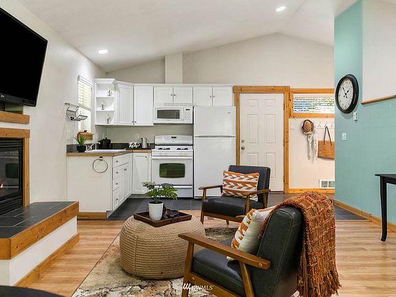 ADU kitchen and cozy living room with propane fireplace. >