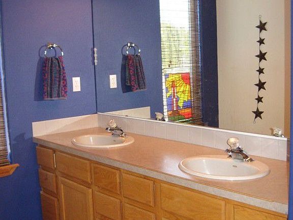 Master bath with double sinks, separate toilet/shower area