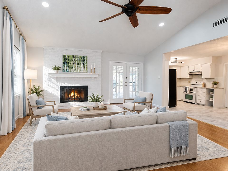Virtual Staging AI, Living Room, Vaulted Ceiling, Open Layout, XL Ceiling Fan, Recessed Lighting, Wood Burning Fireplace, French Doors to Covered Patio