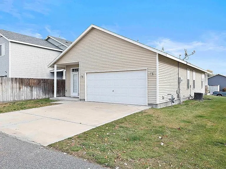 Double car garage, back of house with small yard area