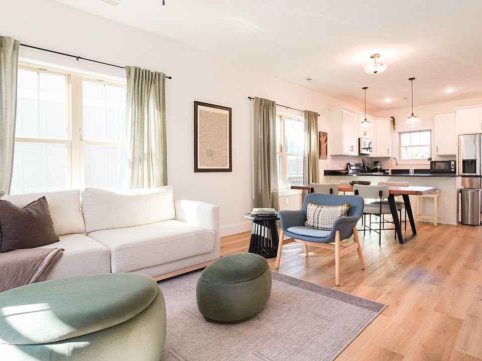 Bright, open living room with luxury vinyl plank flooring and abundant natural light."