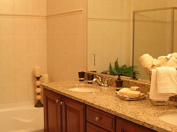 Granite and ceramic tile are standard finishes throughout all of the baths.
