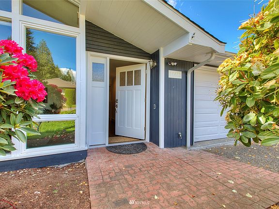 Covered front entry with brick walk-way. 