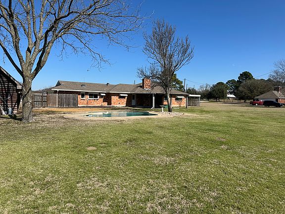 Back of house with inground pool