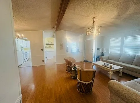 View from hallway. Seeing the front door, living room to the right, dining room to the left, and kitchen and large kitchen nook straight ahead.