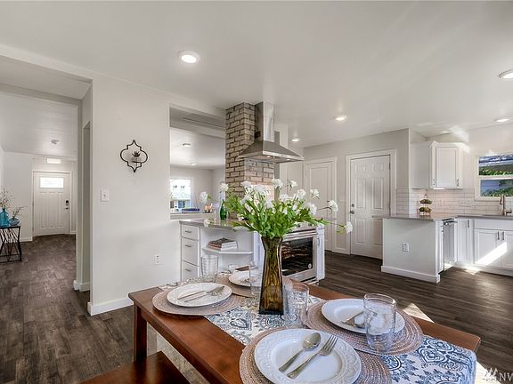 Enticing Kitchen with Gas Range Featuring Convenient Shelving & Cabinet Space