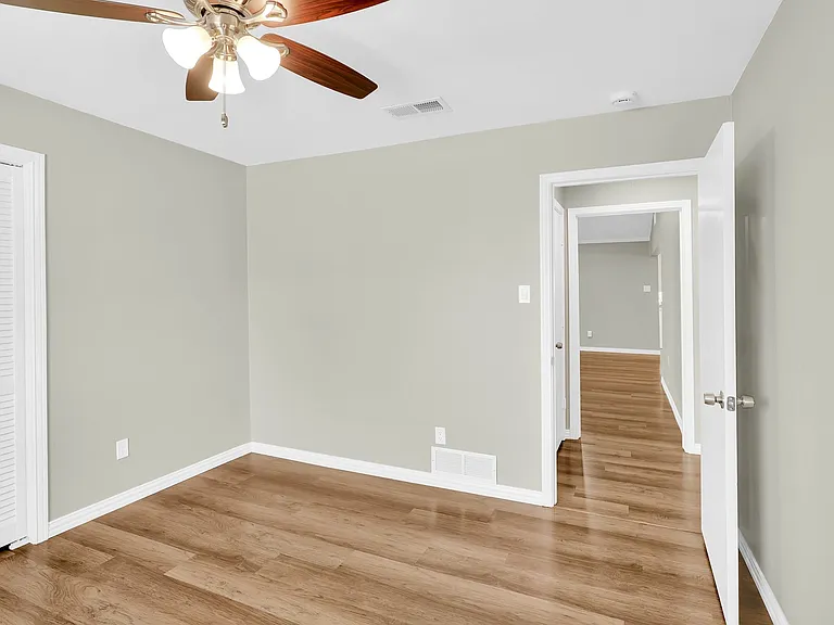 Separate floorplan has two bedrooms on one side of the home and the primary on the other side of the living room. Lots of privacy.