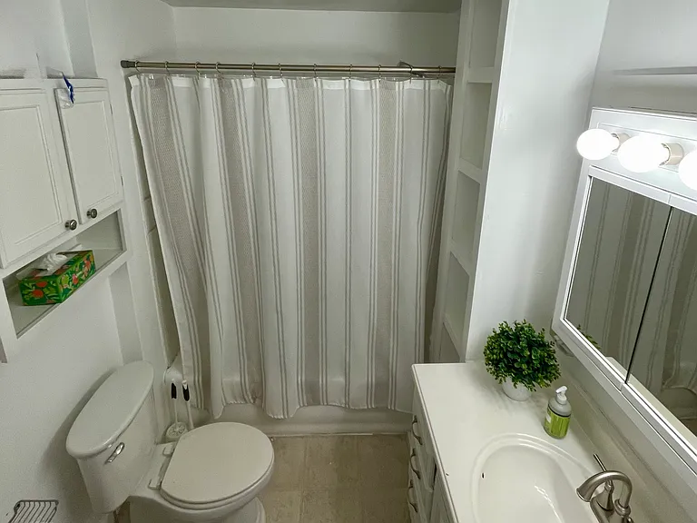 Shared full bathroom with tub.