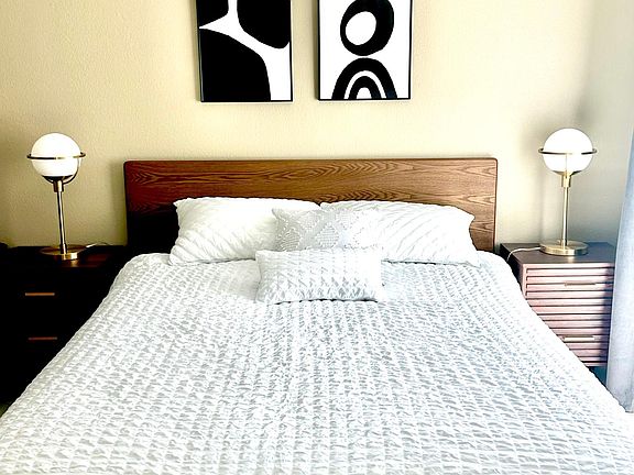 Brand new queen size bed and bedding, bedside tables and lamps.