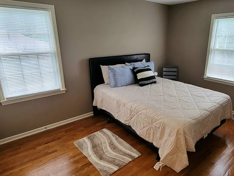 2nd bedroom furnished with queen size bed, hardwood floors, new bedding and rug, double closet space.