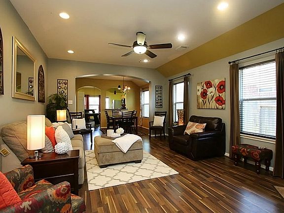 Beautiful family room with upgrade fan and blinds and drapes.